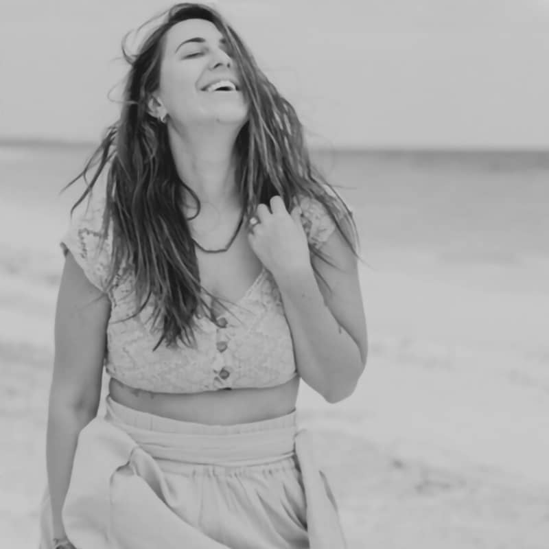 Elizabeth Faye smiling on a beach