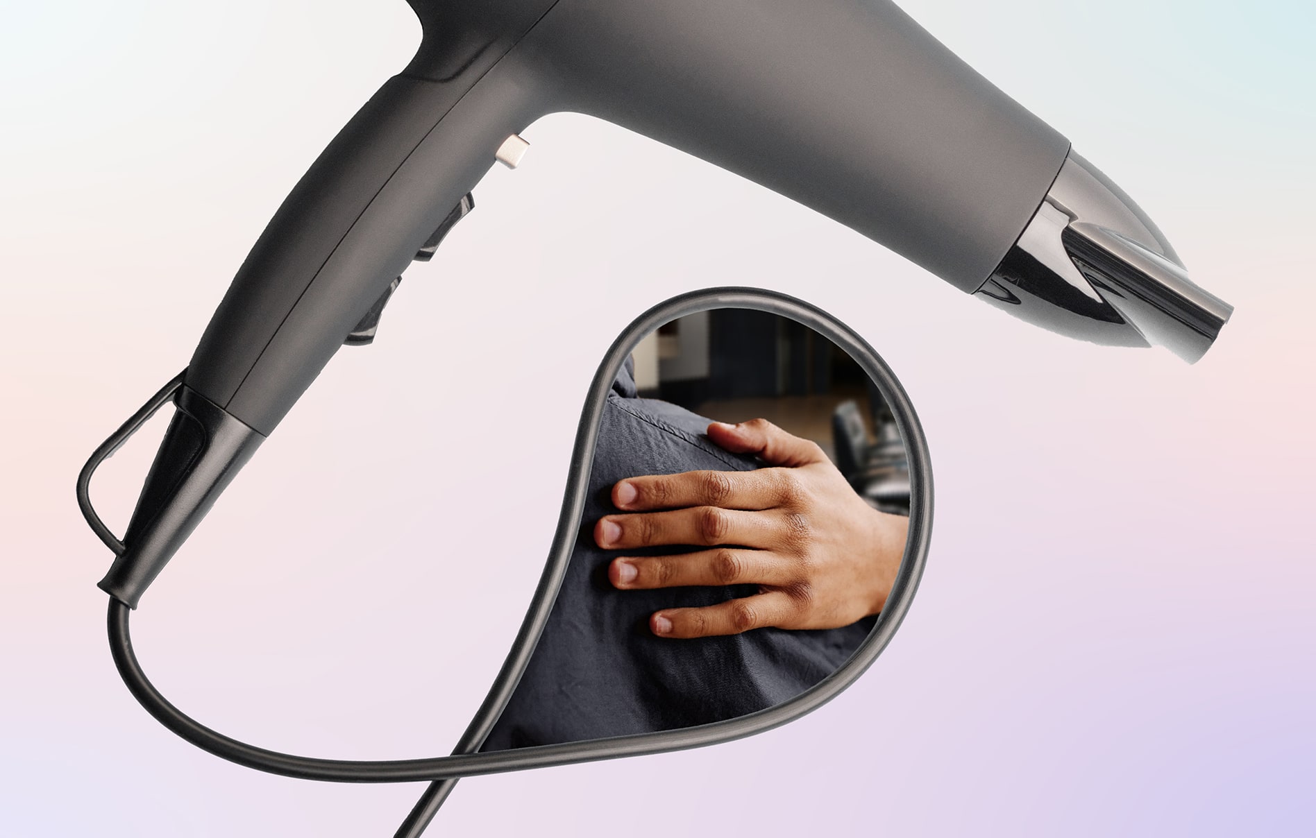 A person putting their hand on the shoulder of another person framed in the loop of a hair dryer's cord